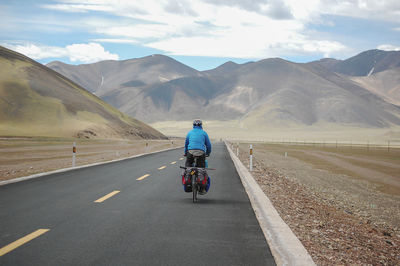 A newly built flat asphalt road leads to the beautiful mountains ahead