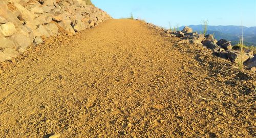 View of rocks on road against sky