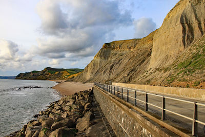 Scenic view of sea and mountains against sky