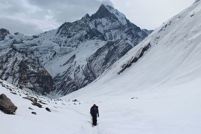 People skiing on snow covered landscape