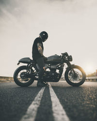 Side view of man riding bicycle on road