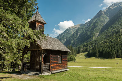 Chapel on field against sky