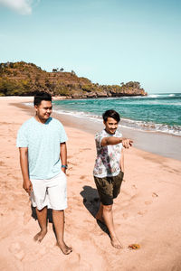 Full length of a young man on beach