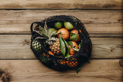 High angle view of fruits in basket on table