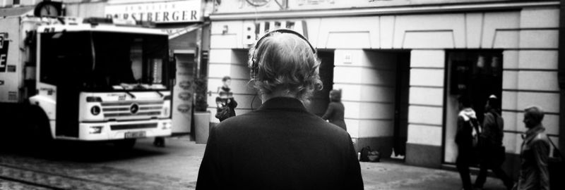 Rear view of woman standing in city