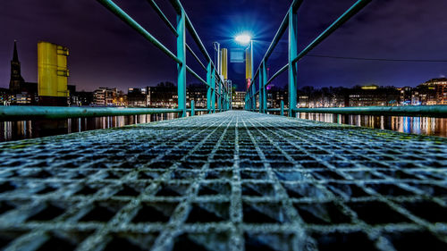 Surface level of illuminated bridge against sky at night