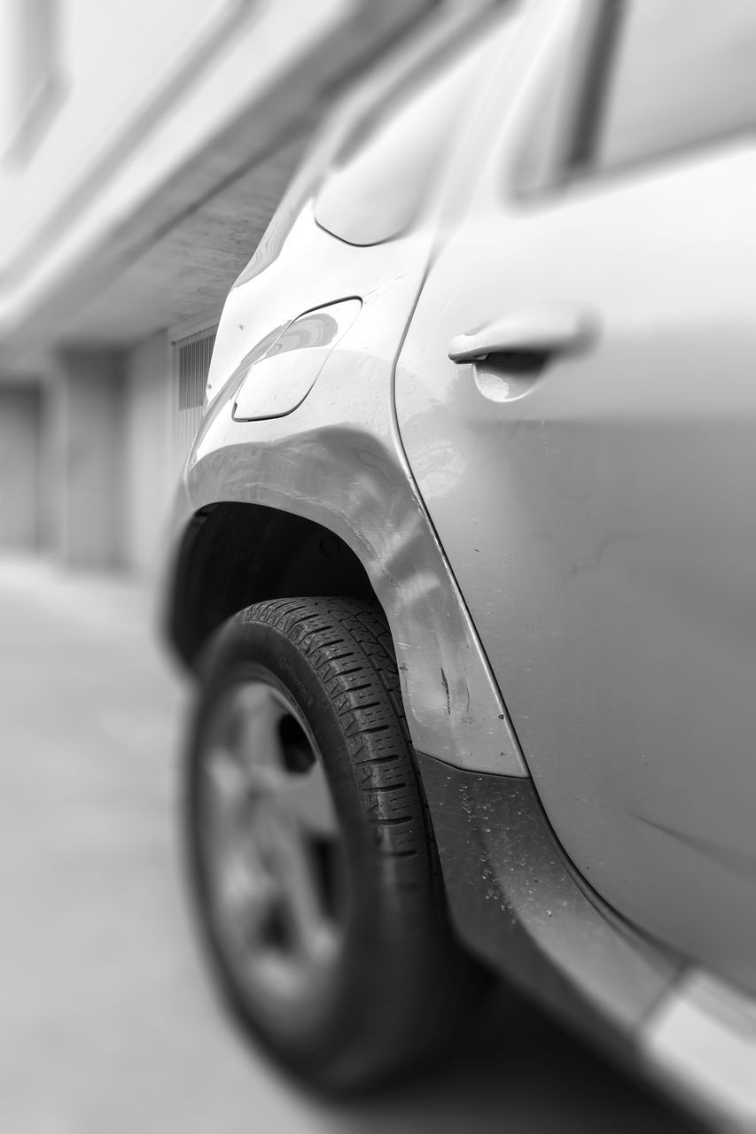 CLOSE-UP OF CAR ON STREET