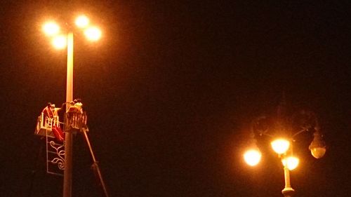 Low angle view of lamp post at night