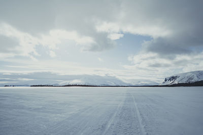 Scenic view of snowcapped landscape against sky