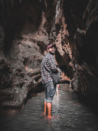 Rear view of man standing in lake