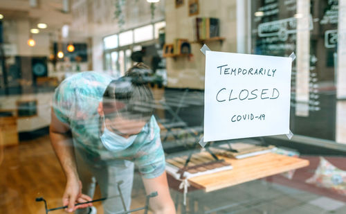 Man wearing mask working in closed door