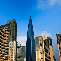 Low angle view of buildings against blue sky