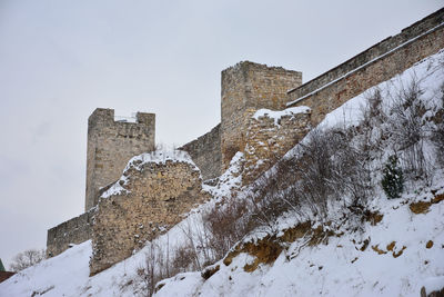 Low angle view of castle against sky during winter