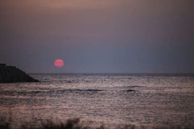 Scenic view of sea against clear sky during sunset