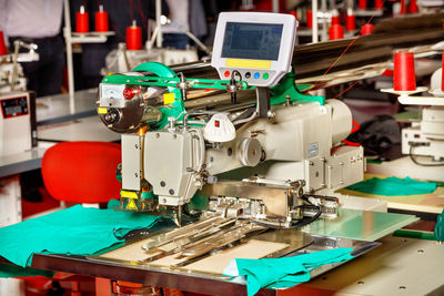 Modern sewing equipment in a sewing factory, a sewing machine with programmable functions close-up.