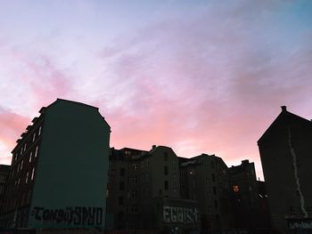 Low angle view of buildings against sky at sunset