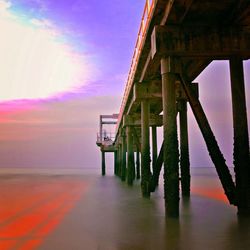 Bridge over sea at sunset