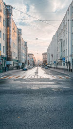 Surface level of road by buildings against sky