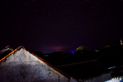 Low angle view of illuminated building against sky at night