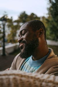 Smiling mature man with eyes closed