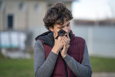 A guy with love and tenderness presses a newborn labrador puppy to his face. love concept 