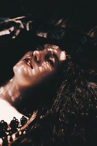 High angle portrait of young woman lying down