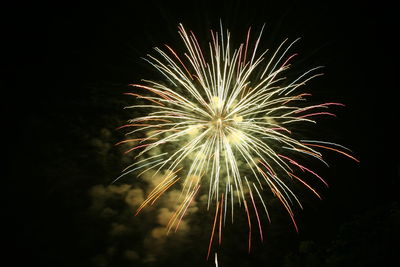 Low angle view of firework display at night