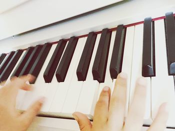 Low angle view of person playing piano
