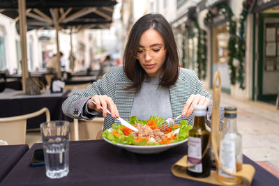 Portrait of young woman having food