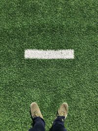 Low section of man standing on ground