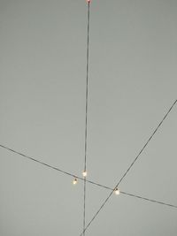 Low angle view of cables against sky