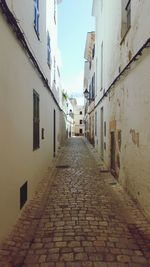 Alley amidst buildings against sky