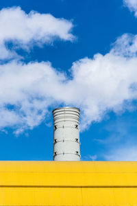 Low angle view of smoke stack against sky