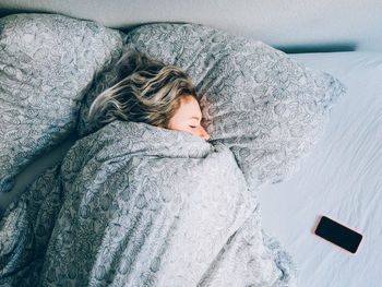 High angle view vie of woman sleeping on bed