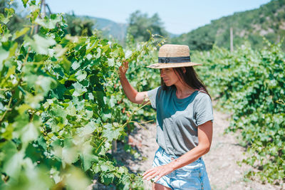 Woman wearing hat standing in farm