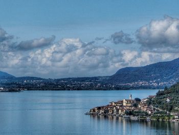 Scenic view of sea and city against sky