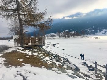 Scenic view of snow covered field against sky