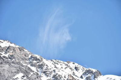 Low angle view of mountains against clear blue sky