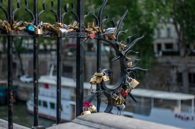 Close-up of padlock hanging on metal structure in city