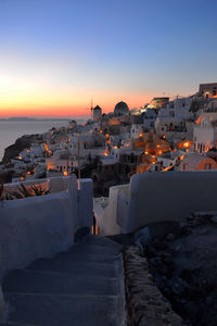 Illuminated houses at santorini during sunset