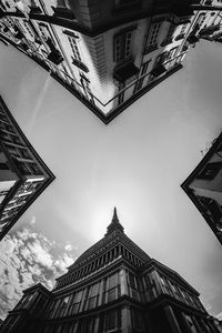 Low angle view of buildings against cloudy sky