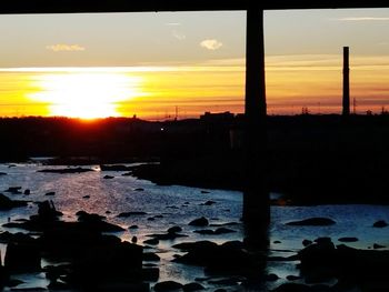 Silhouette bridge against sky during sunset