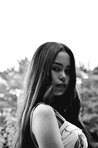 Portrait of a beautiful young woman against sky