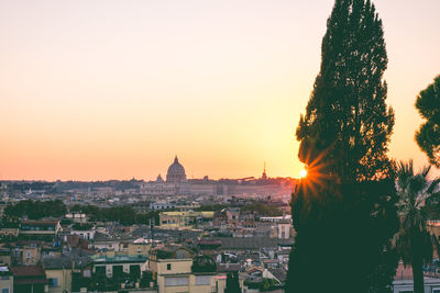 View of buildings in city at sunset