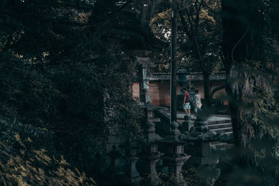 Reflection of people on building in forest