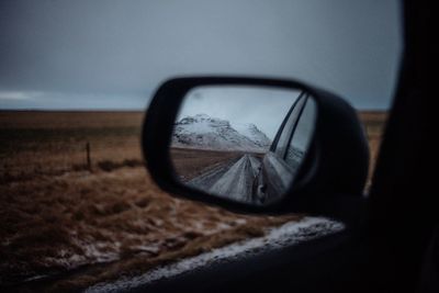 Close-up of side-view mirror of car