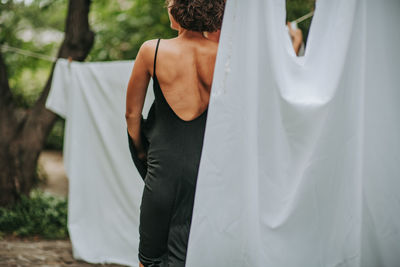 Rear view of couple standing against white background