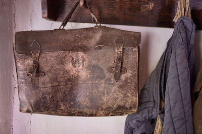 Close-up of clothes hanging on old wall