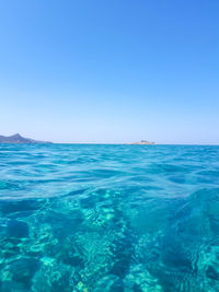 Scenic view of sea against clear blue sky