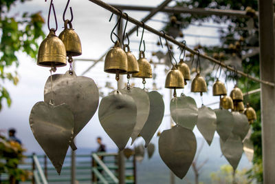 Low angle view of lanterns hanging on metal fence